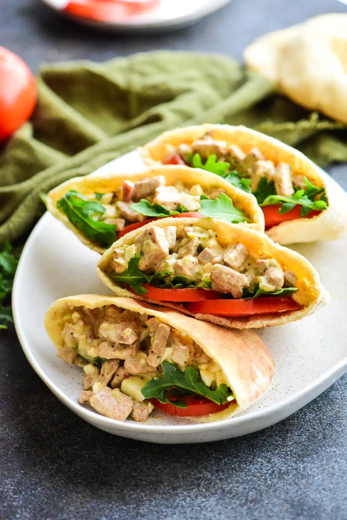 four tuna salad pita pockets on a large serving plate